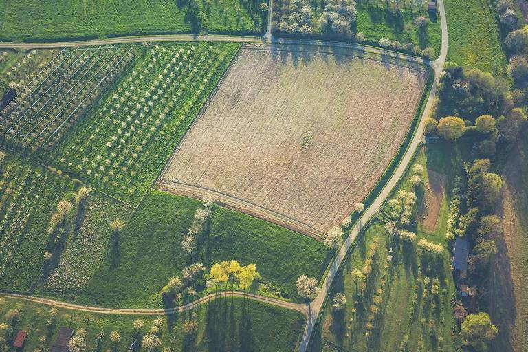 An aerial view from farmland and fields